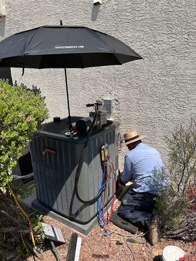 HVAC technician performing outdoor AC maintenance in Elkhart
